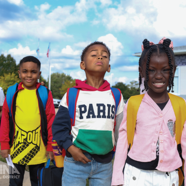  Three students with smiles ready for the first day of school